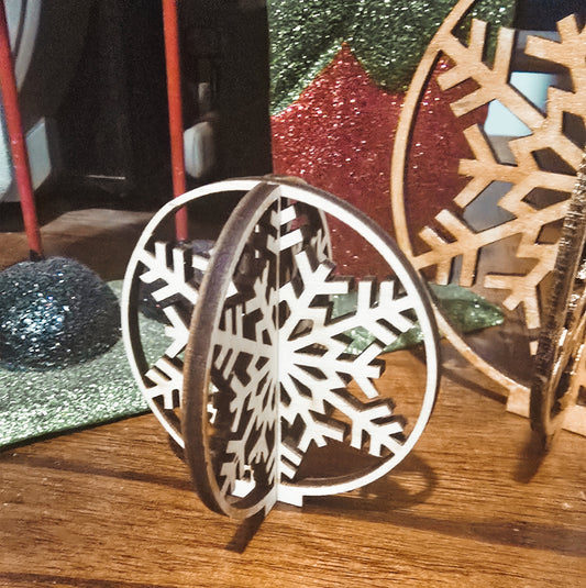 Decorative wooden snowflake ornament on a wooden surface with a blurred background