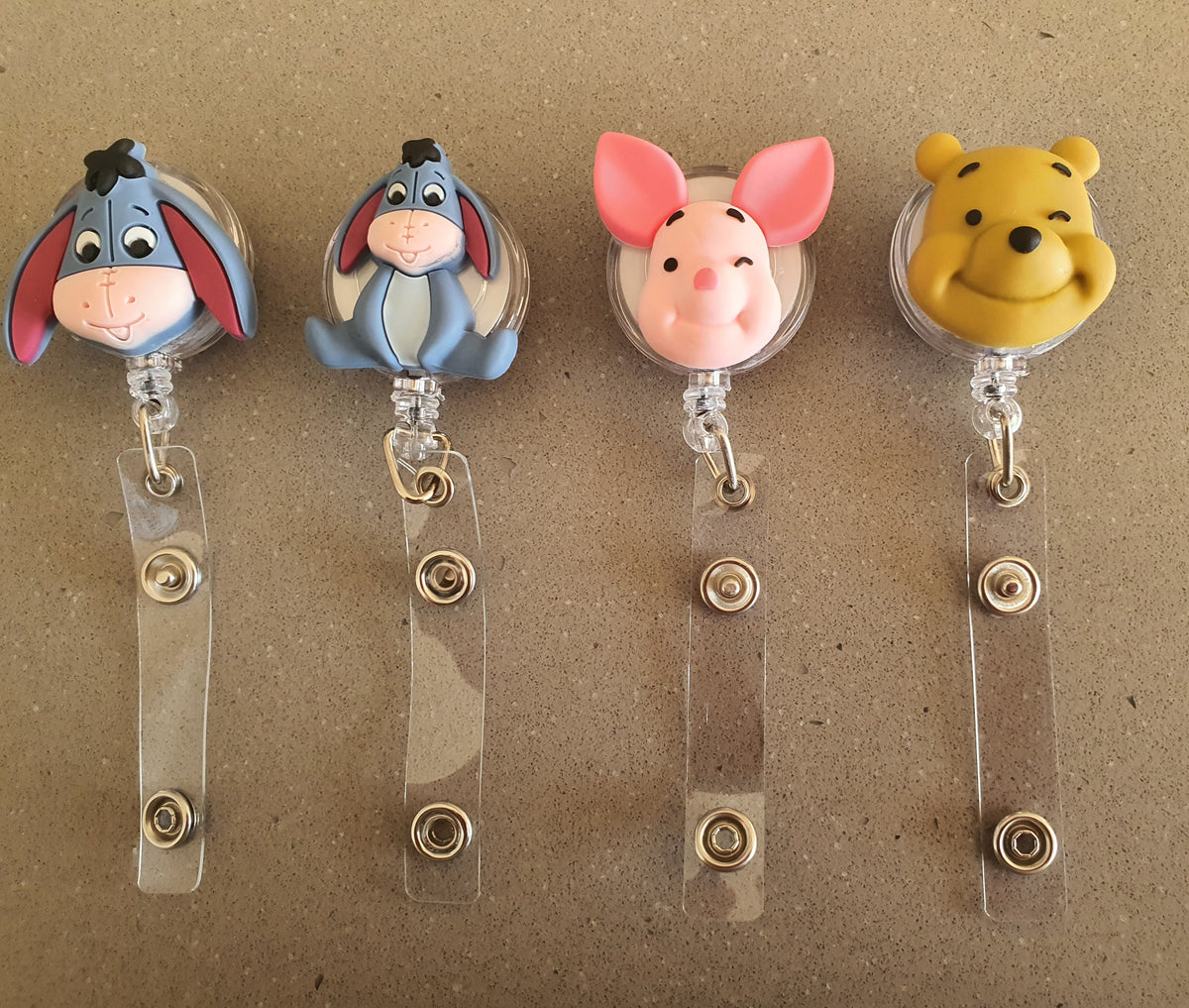 Kids cartoon badge reels with colorful PeppaTree Designs characters, featuring retractable ID card holders for children.