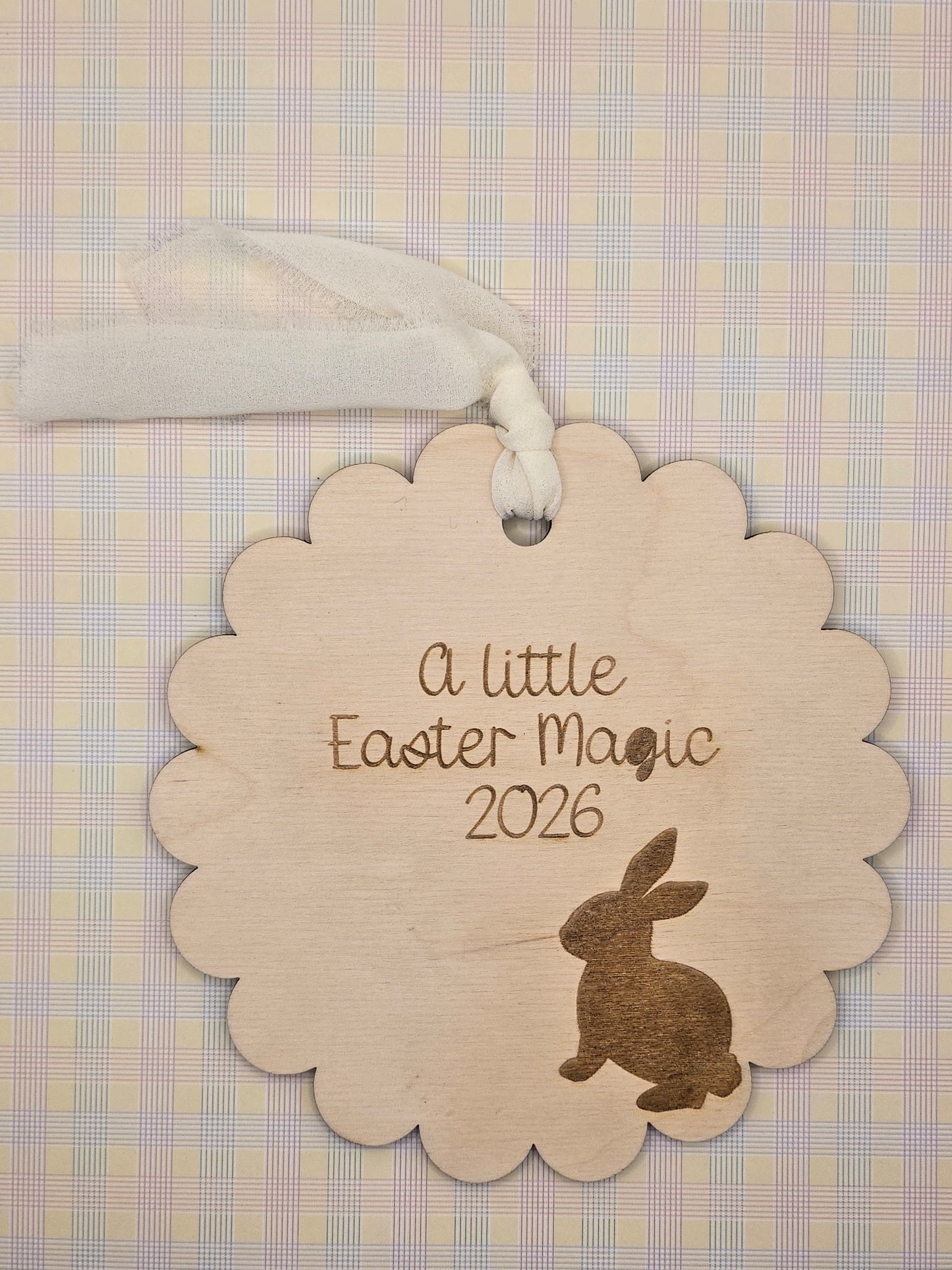 Decorative Easter tag with text and a rabbit silhouette on a checkered background