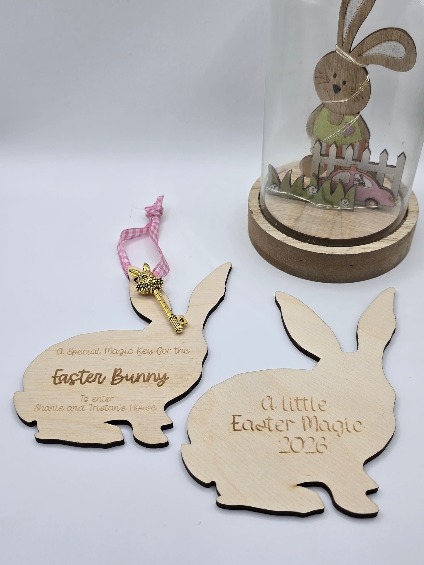 Wooden Easter bunny and chick cutouts with decorative elements on a white background