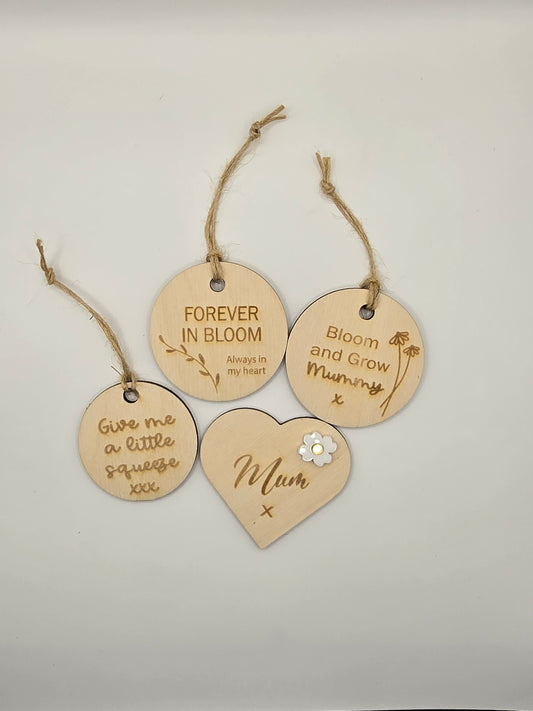 Set of wooden tags with engraved messages on a light gray background