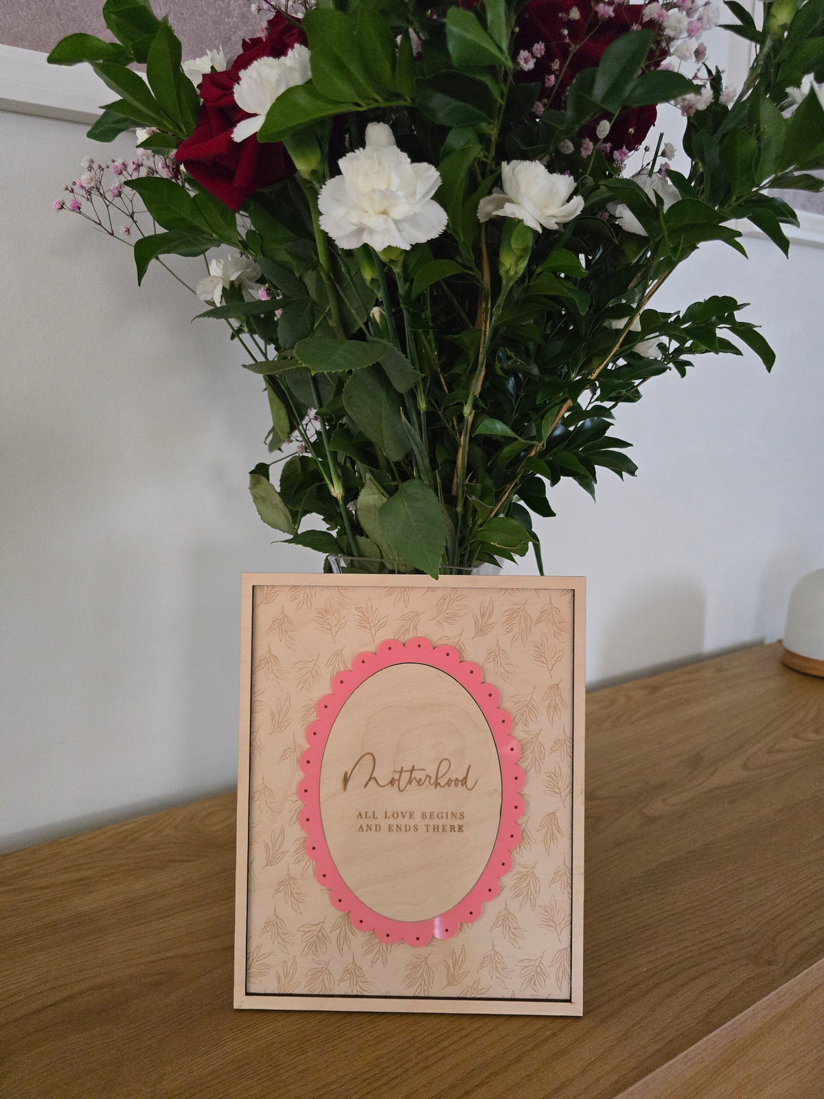 Motherhood wall decor plaque by PeppaTree Designs featuring a heartfelt message on a rustic wall sign.