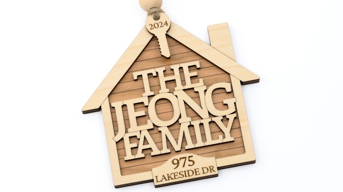 Wooden house-shaped ornament with 'The Jeong Family' and address on a white background
