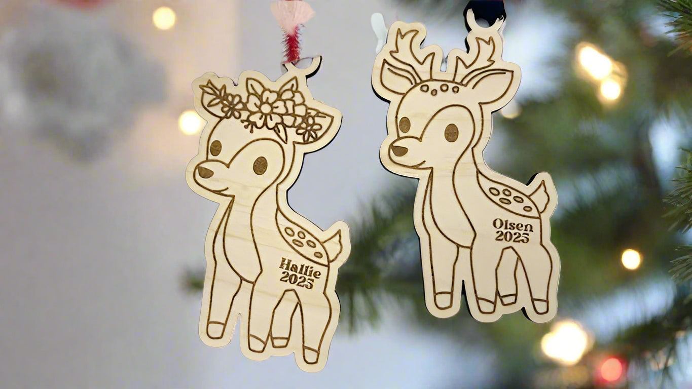 Two wooden deer ornaments with personalized names on a light background