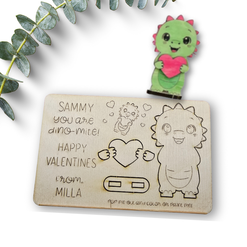 Valentine's Day card with a dinosaur illustration and a small dinosaur figurine holding a heart, surrounded by green leaves.