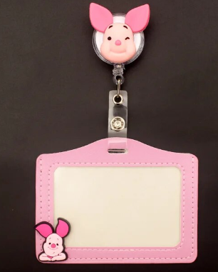 Pink cartoon piglet ID card holder and retractable badge reel featuring PeppaTree Designs, ideal for kids.