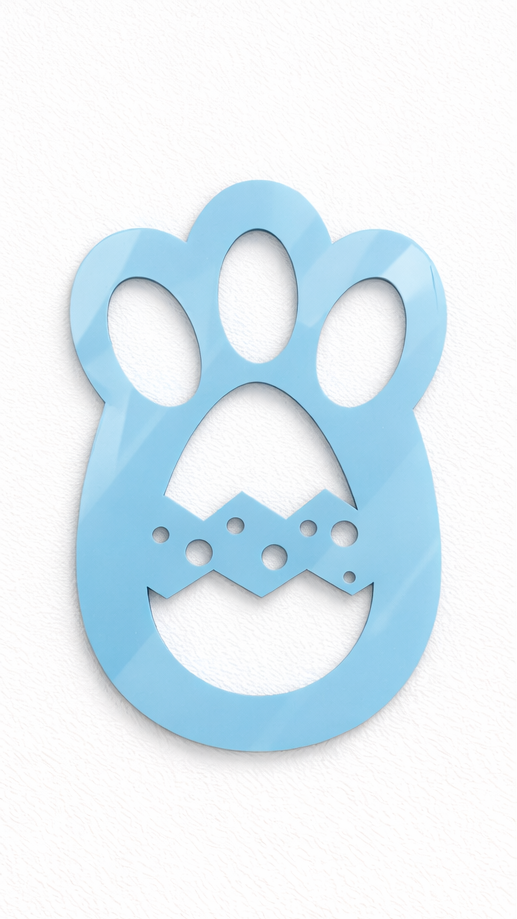 Wooden stencils shaped like paw prints and a bunny, with white powder resembling snow on a textured surface.