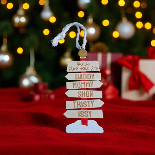 Personalized North Pole name sign ornament by PeppaTree Designs featuring festive holiday decor with a red and green design.