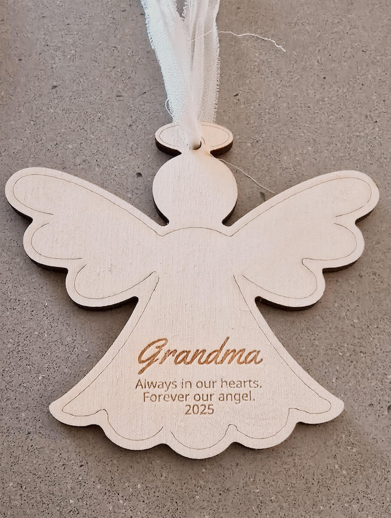 Angel-shaped ornament with 'Grandma' and personalized text on a gray background