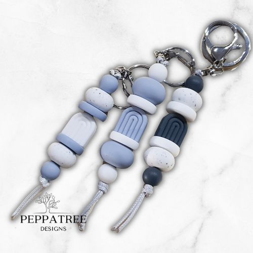 Handmade boho blue storm keyring from PeppaTree Designs, featuring a stylish arch design and durable lanyard holder.
