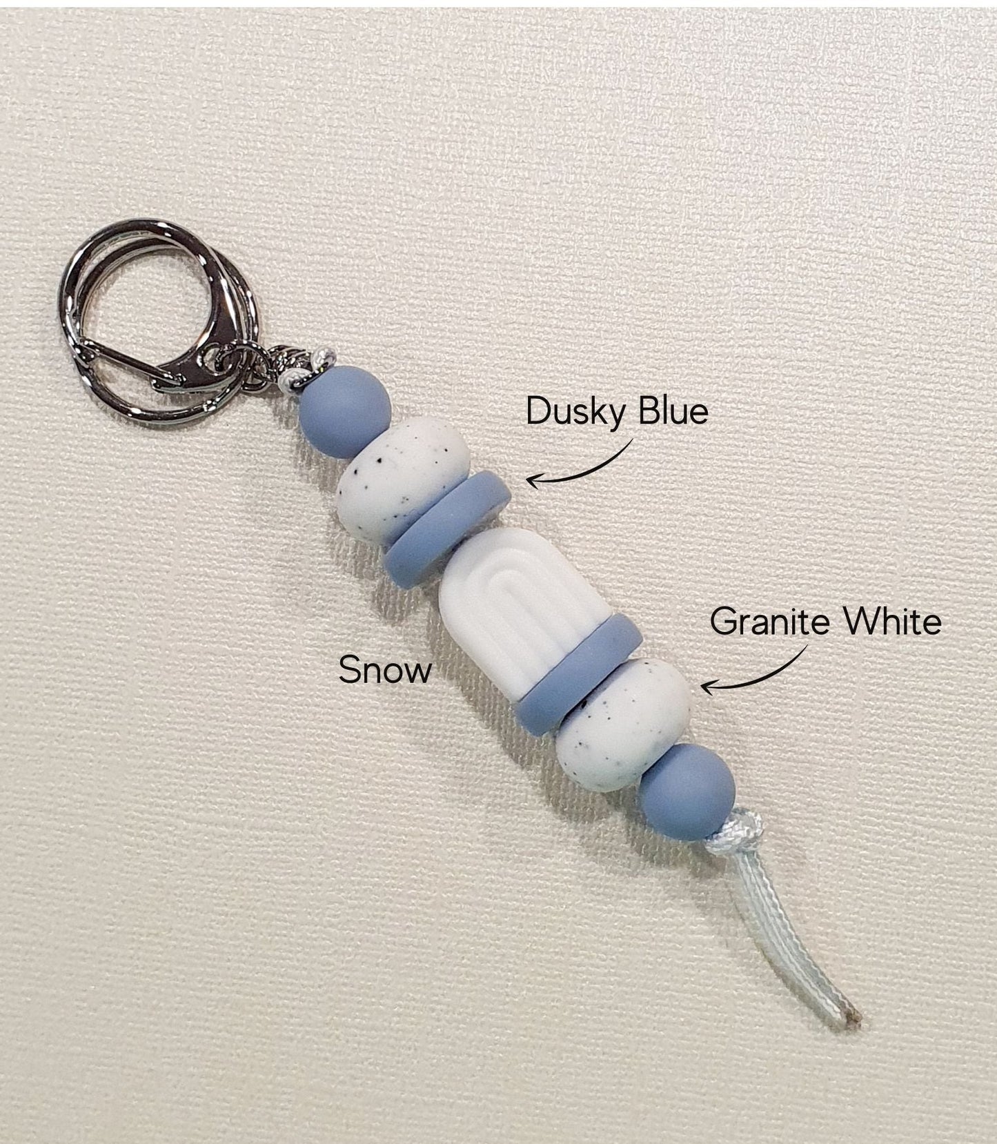 Handmade blue storm boho arch keyring from PeppaTree Designs, ideal as a lanyard or keychain with vibrant, artistic design.