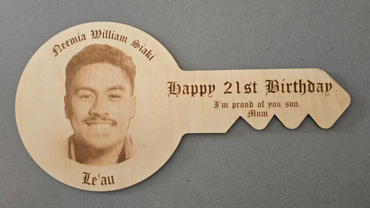 Key-shaped card with a portrait and text on a gray background