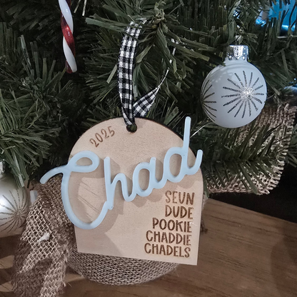 Christmas tree ornament with 'Chad' tag and decorative ribbons.