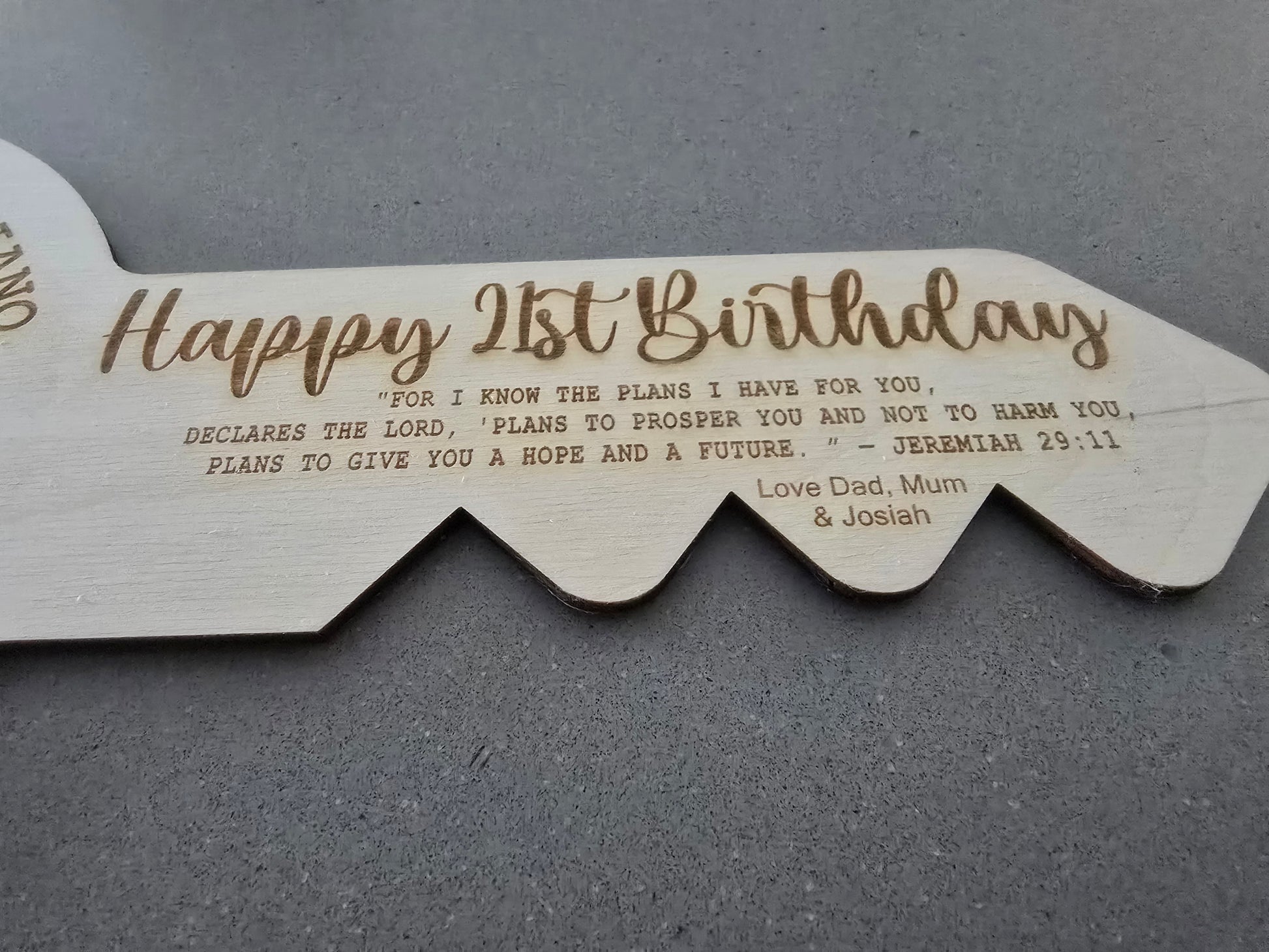 Laser cut custom engraved 21st key by PeppaTree Designs, featuring intricate design details on a metal key.