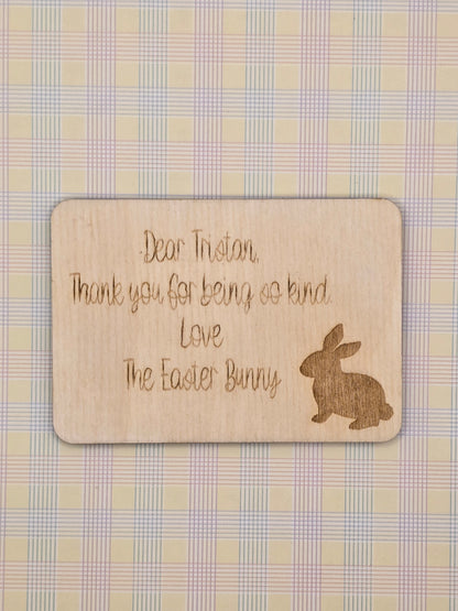 Wooden card with engraved text and Easter Bunny silhouette on a checkered background