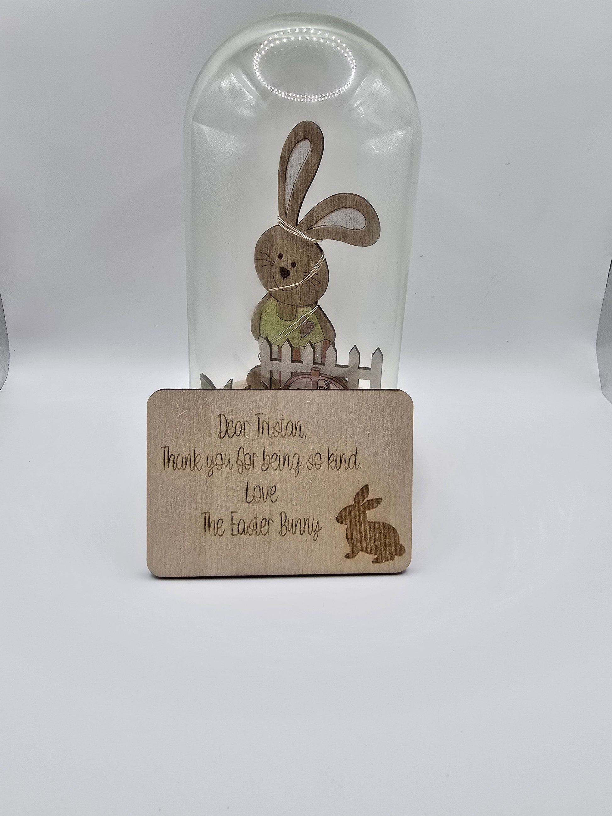 Glass bottle with wooden coaster featuring Easter-themed design on a white background
