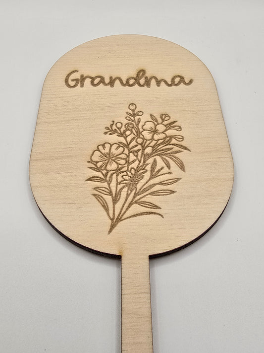 Personalised flower and garden keepsake stakes by PeppaTree Designs in five unique designs, displayed in a sunny garden setting.