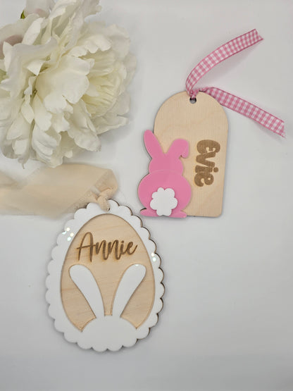 Decorative wooden tags with 'Evie' and 'Annie' on a white background with flowers.