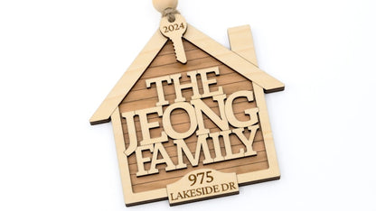 Wooden house-shaped ornament with 'The Jeong Family' and address on a white background