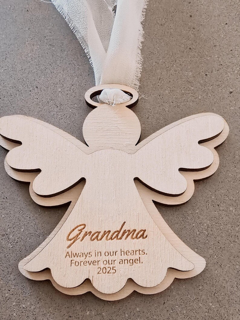 Wooden angel ornament with 'Grandma' engraved on a neutral background