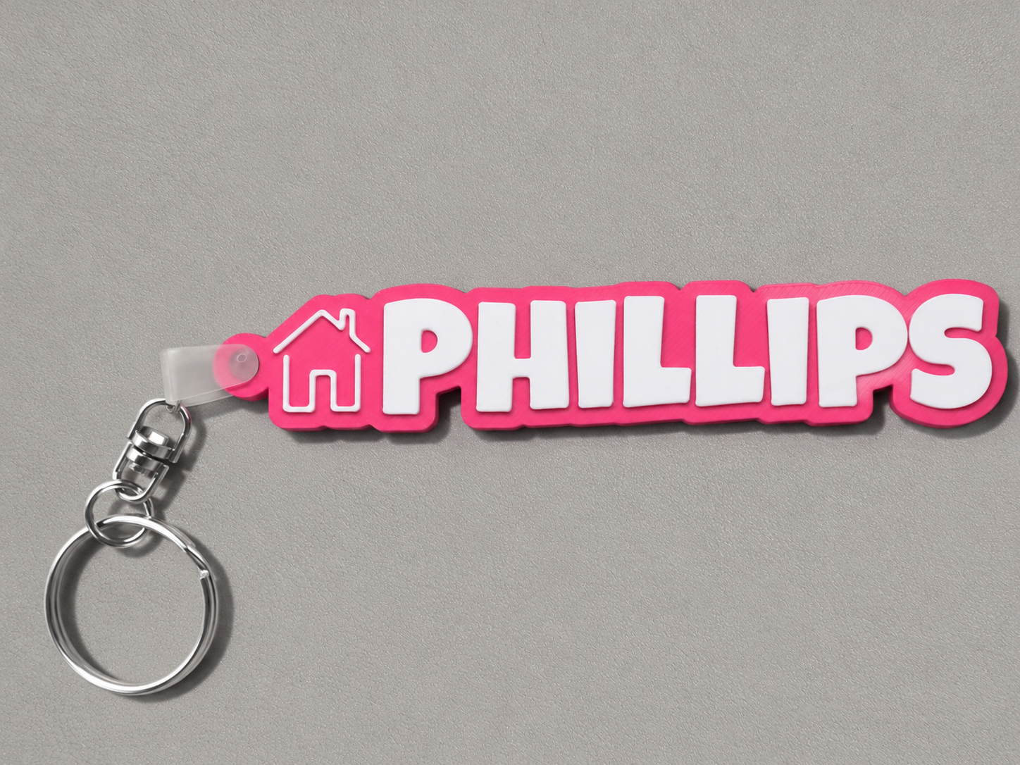 Pink and white keychain with 'PHILLIPS' branding on a gray background