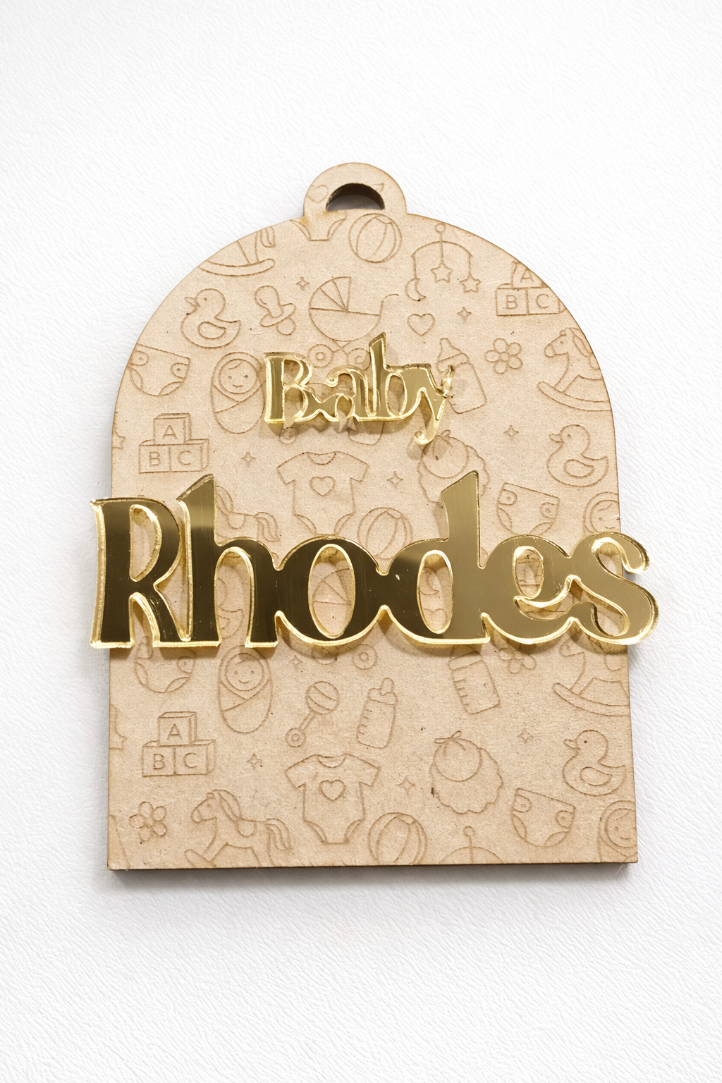 PeppaTree Designs arch baby announcement disc with a colorful name cutout and decorative elements for a baby celebration.