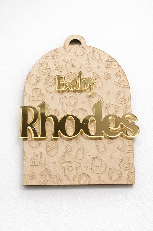 PeppaTree Designs arch baby announcement disc with a colorful name cutout and decorative elements for a baby celebration.