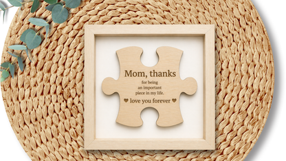 PeppaTree Designs Mom Puzzle Piece wall decor plaque with a heart-shaped design and decorative lettering, suitable for home decor.