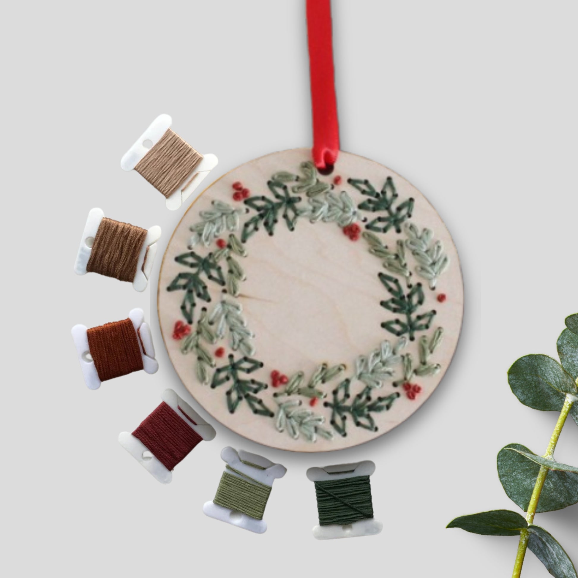 Laser cut embroidery Christmas wreath ornaments by PeppaTree Designs, featuring intricate festive holiday designs.