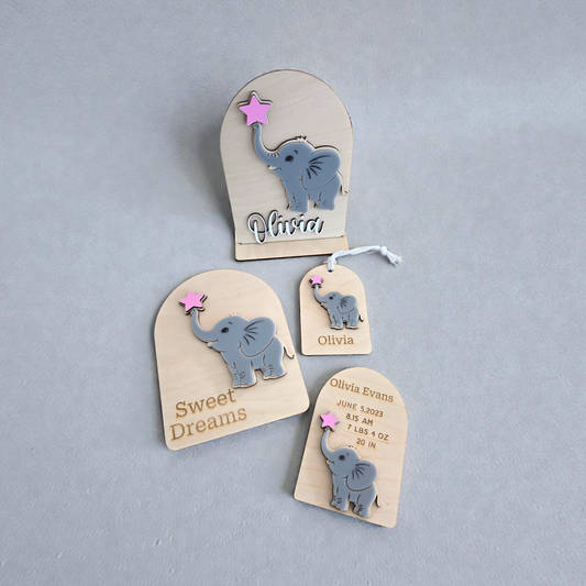 Set of personalized baby tags with elephant designs on a gray background