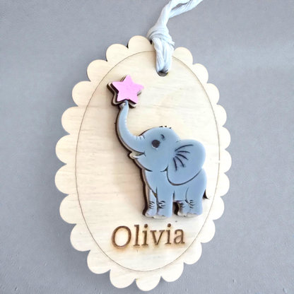 Set of personalized baby tags with elephant designs on a gray background