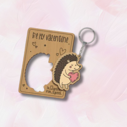 Hedgehog keychain with 'Be My Valentine' text on a soft pink background