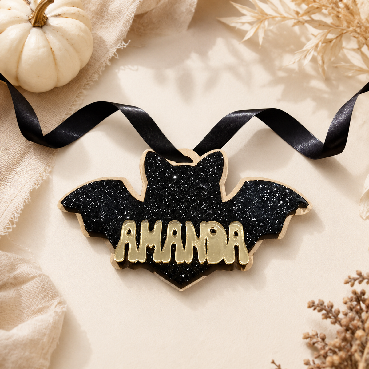 Halloween bat keychain with custom name from PeppaTree Designs, featuring a black bat tag for Halloween-themed accessories.