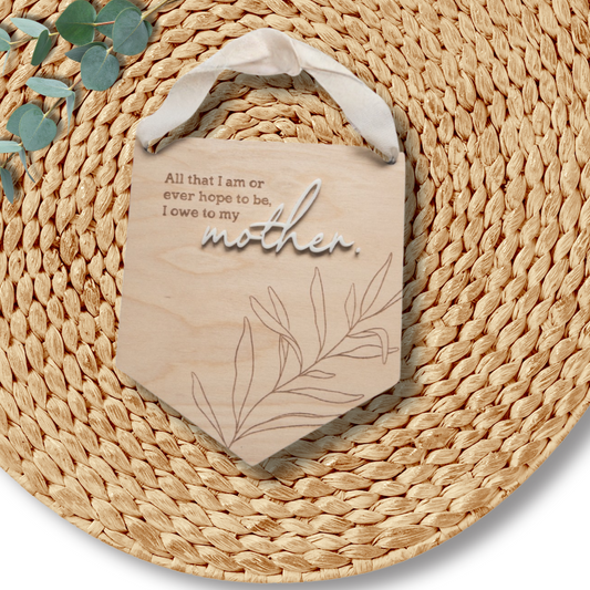 Round woven mat with a decorative bag and eucalyptus leaves on a white background