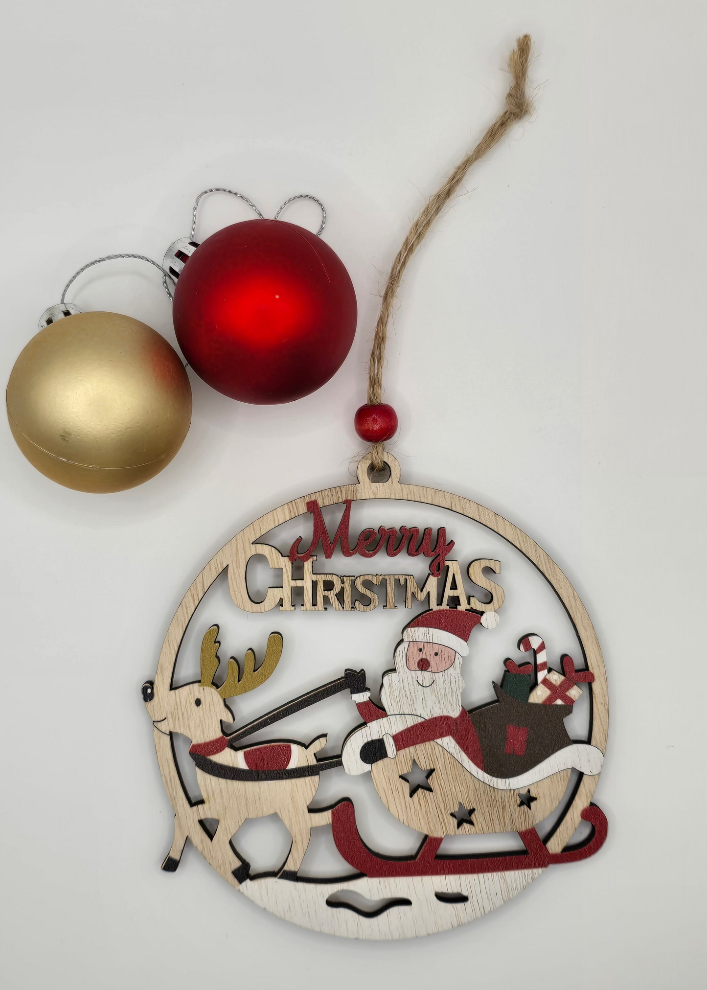 Decorative Christmas ornament with Santa Claus and reindeer on a white background