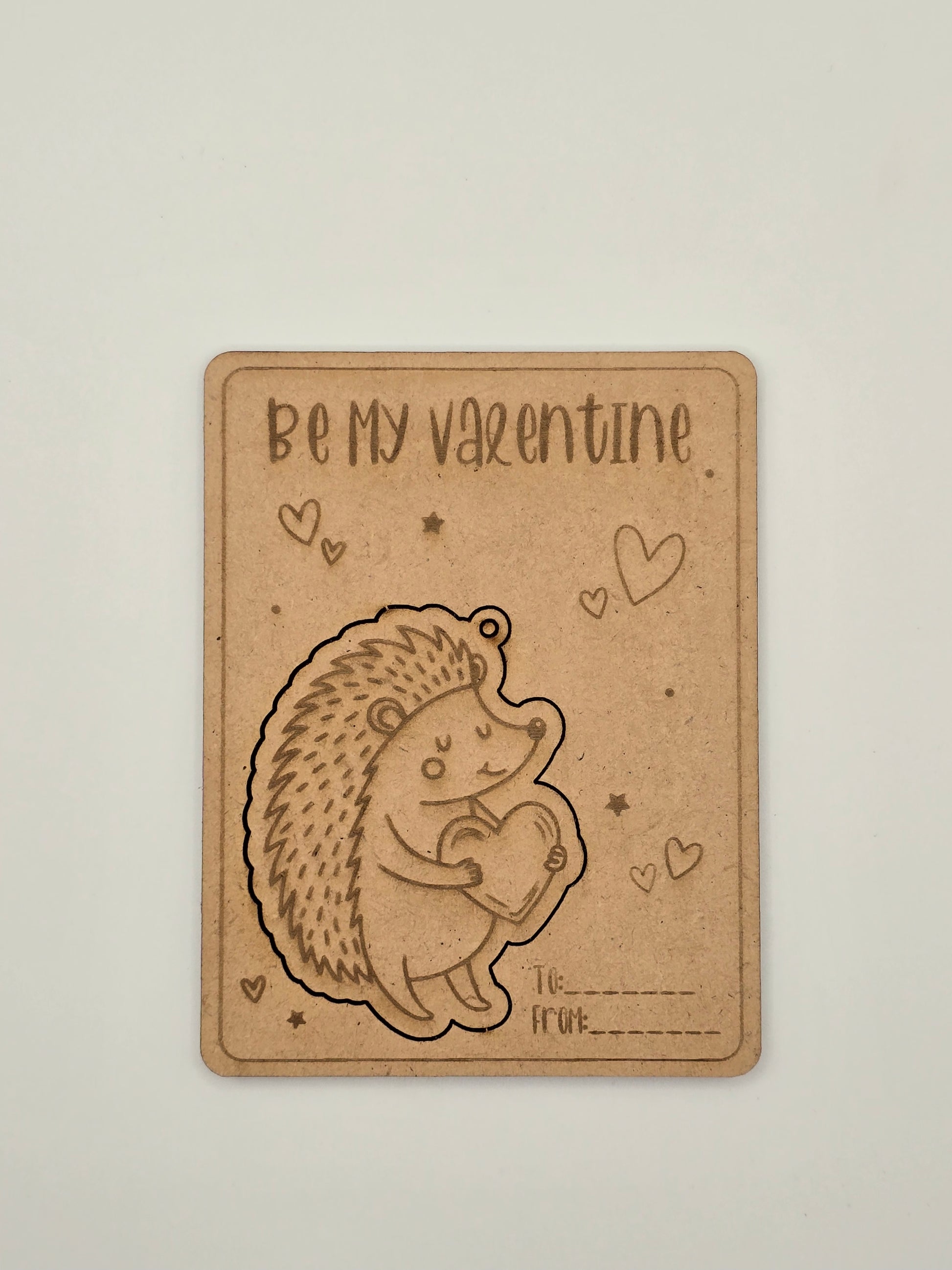 Card with a hedgehog illustration and 'Be my Valentine' text on a beige background