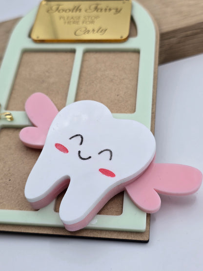 PeppaTree Designs custom tooth fairy door name sign keychain hanging on a door, featuring whimsical design and personalized text.