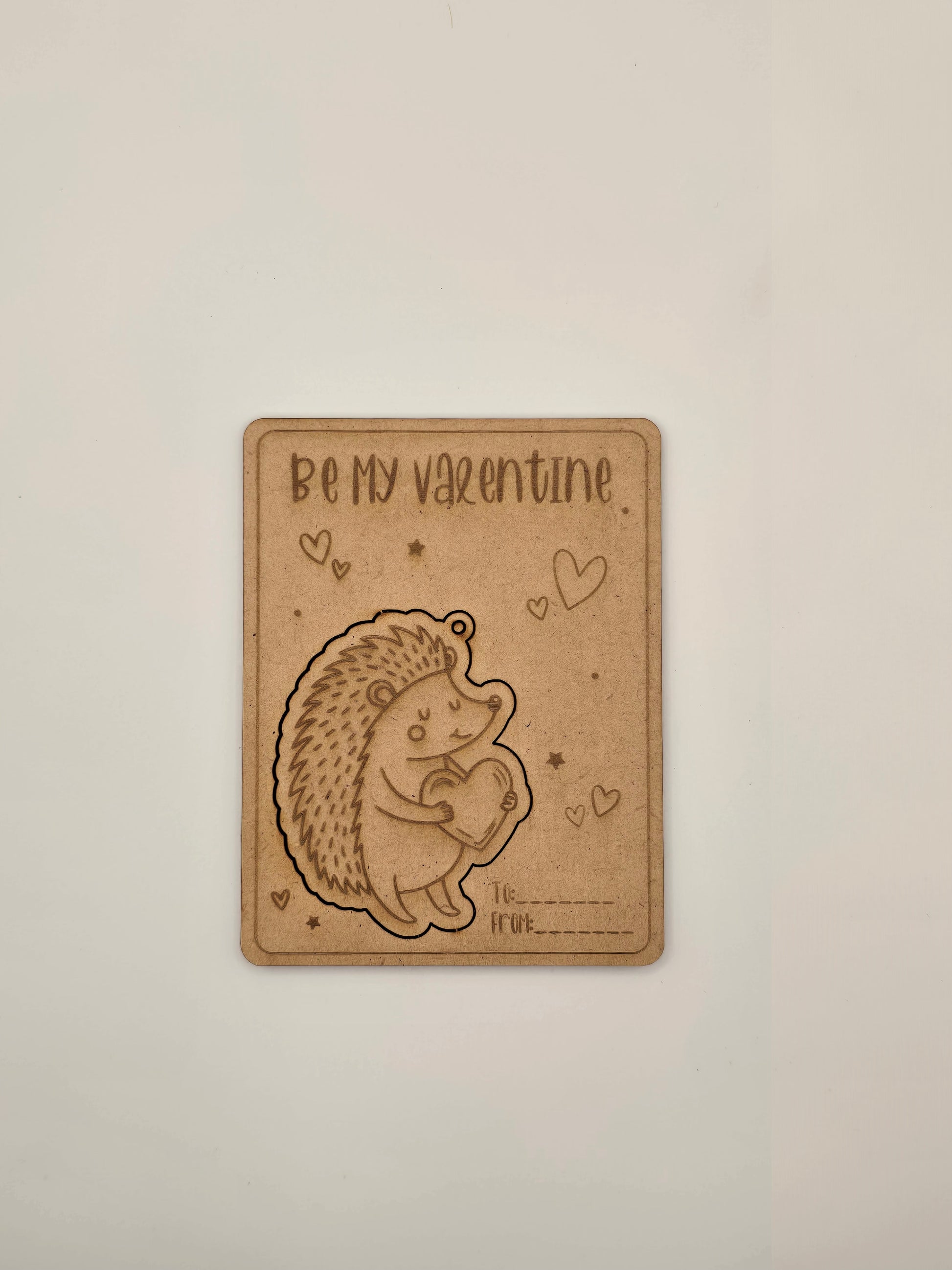 Card with a hedgehog illustration and 'Be my Valentine' text on a beige background