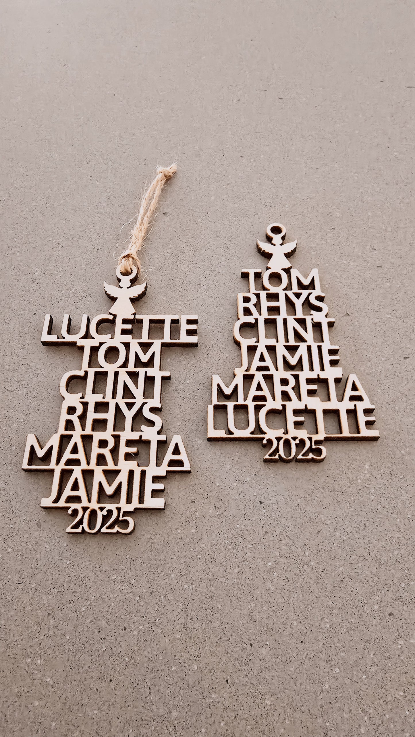 Two wooden name ornaments with engraved names and the year 2025 on a gray background.