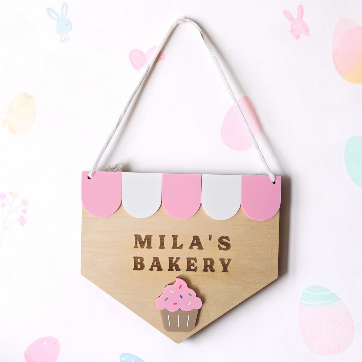 Custom wooden kids decor sign with "Name’s Bakery" from PeppaTree Designs, featuring colorful, handcrafted lettering for a playroom.
