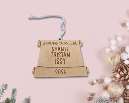 Personalized Christmas ornament on a pink background with festive decorations