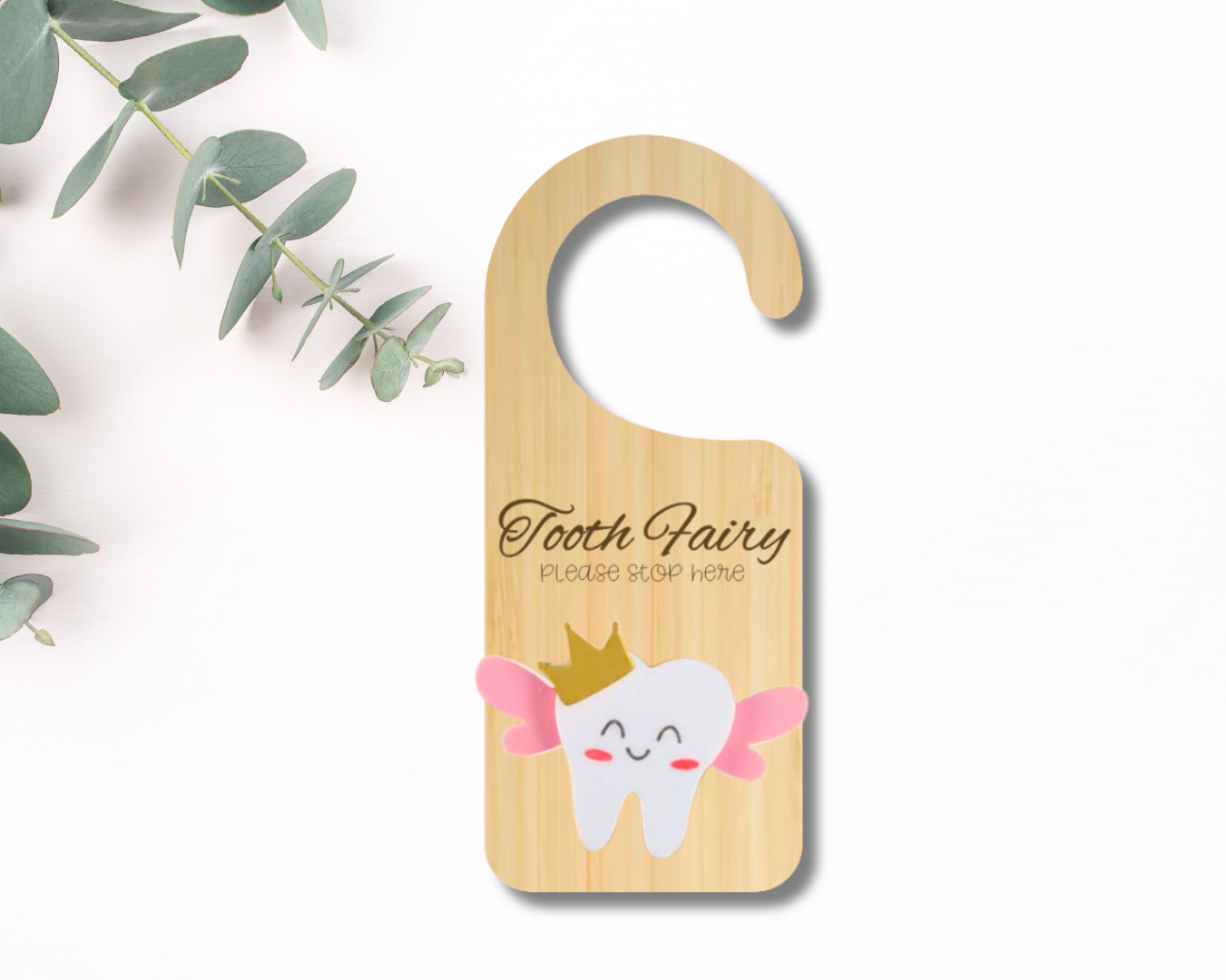 Wooden door hanger with tooth fairy design on a white background